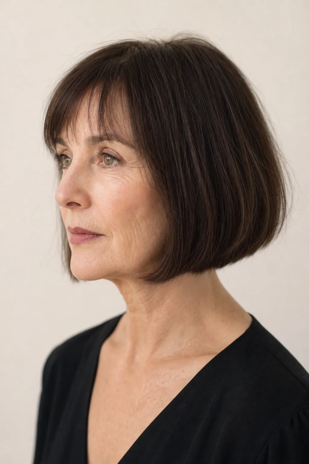 Blunt-perimeter bob with invisible internal layers making the hemline read dense on fine thin hair