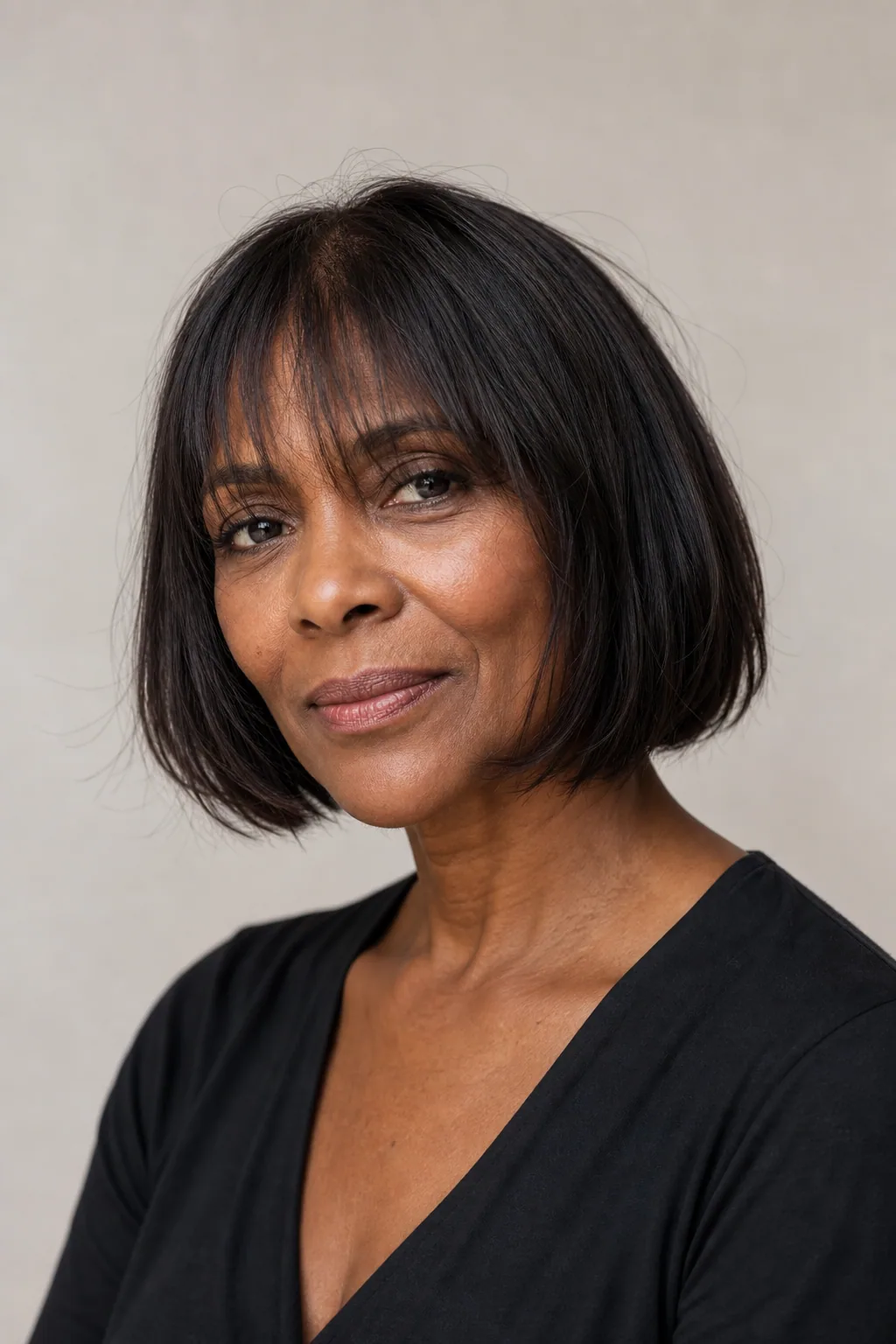 Chin-length bob with soft wispy feathered bangs sitting light on the forehead on fine straight hair
