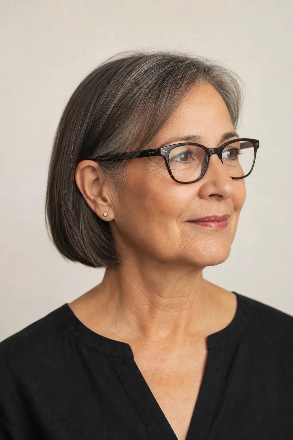 Chin bob cut to tuck behind the ears with glasses on fine thin brunette hair over 60