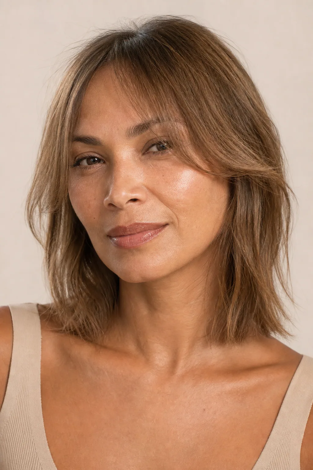 Mid-length fine hair with a soft curtain fringe parted in the middle, sweeping to either side of the face