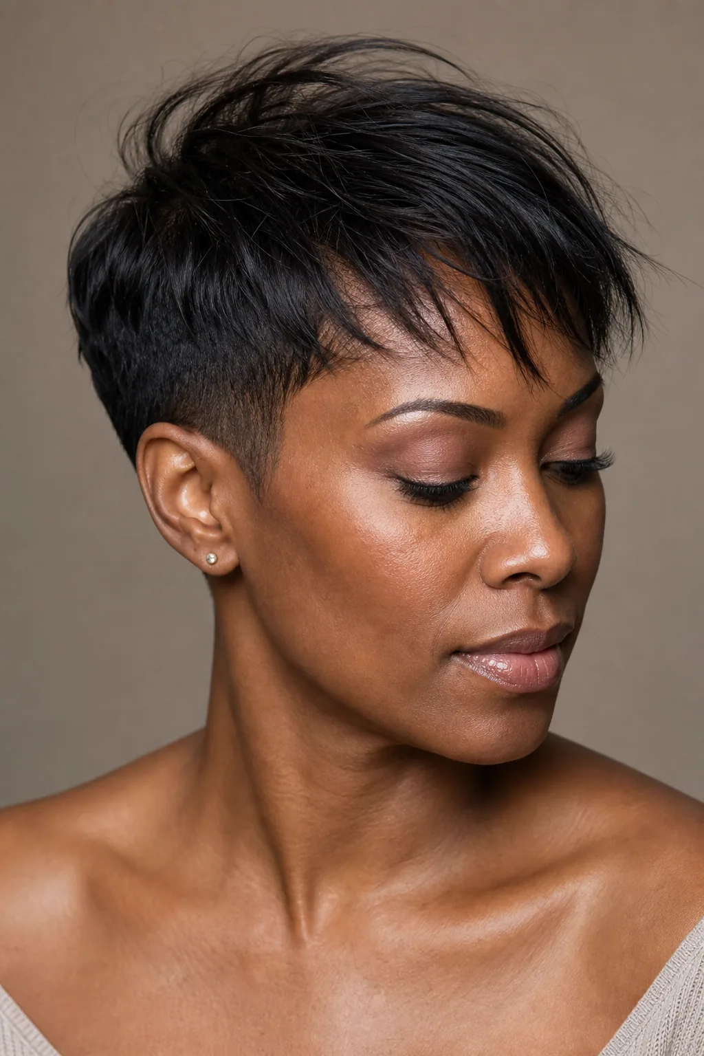 Short crop with both sides taken very close and longer disconnected top, fine hair, strong bone structure