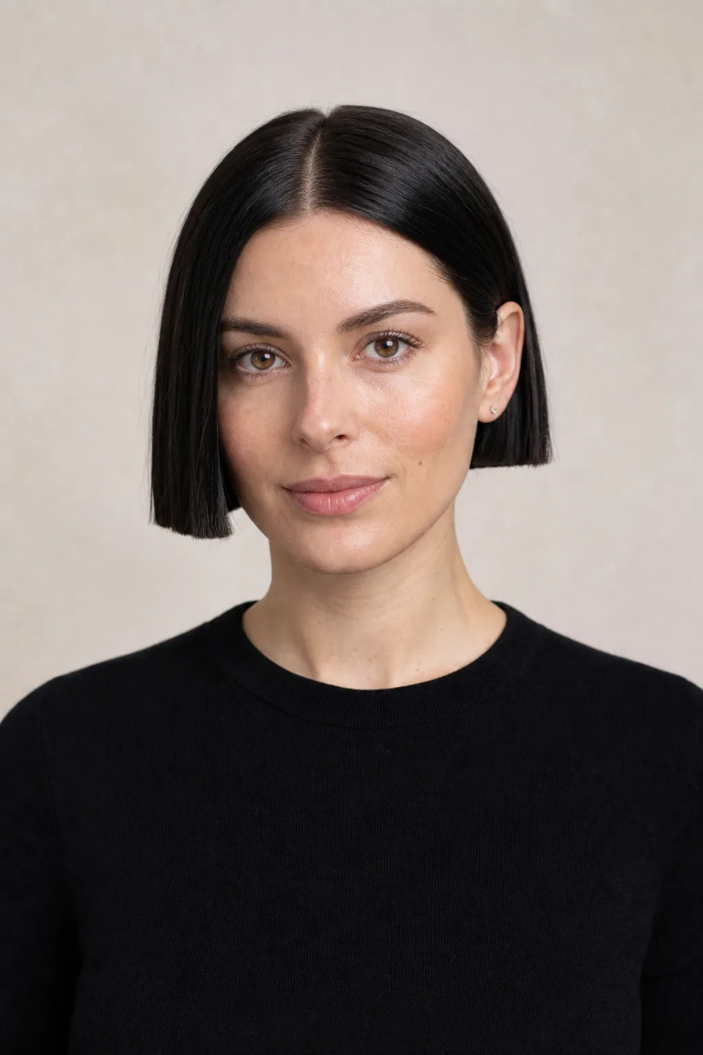 Ear-length blunt bob with a solid hemline on fine straight black hair