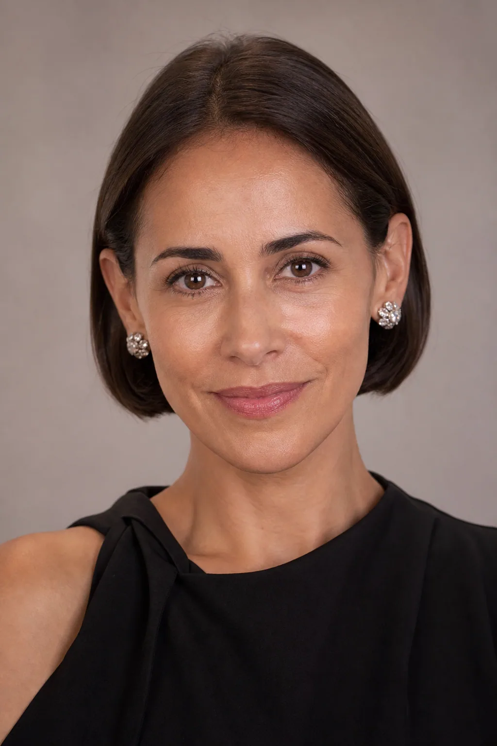 Sleek French bob tucked behind the ears with a glossy finish on fine hair
