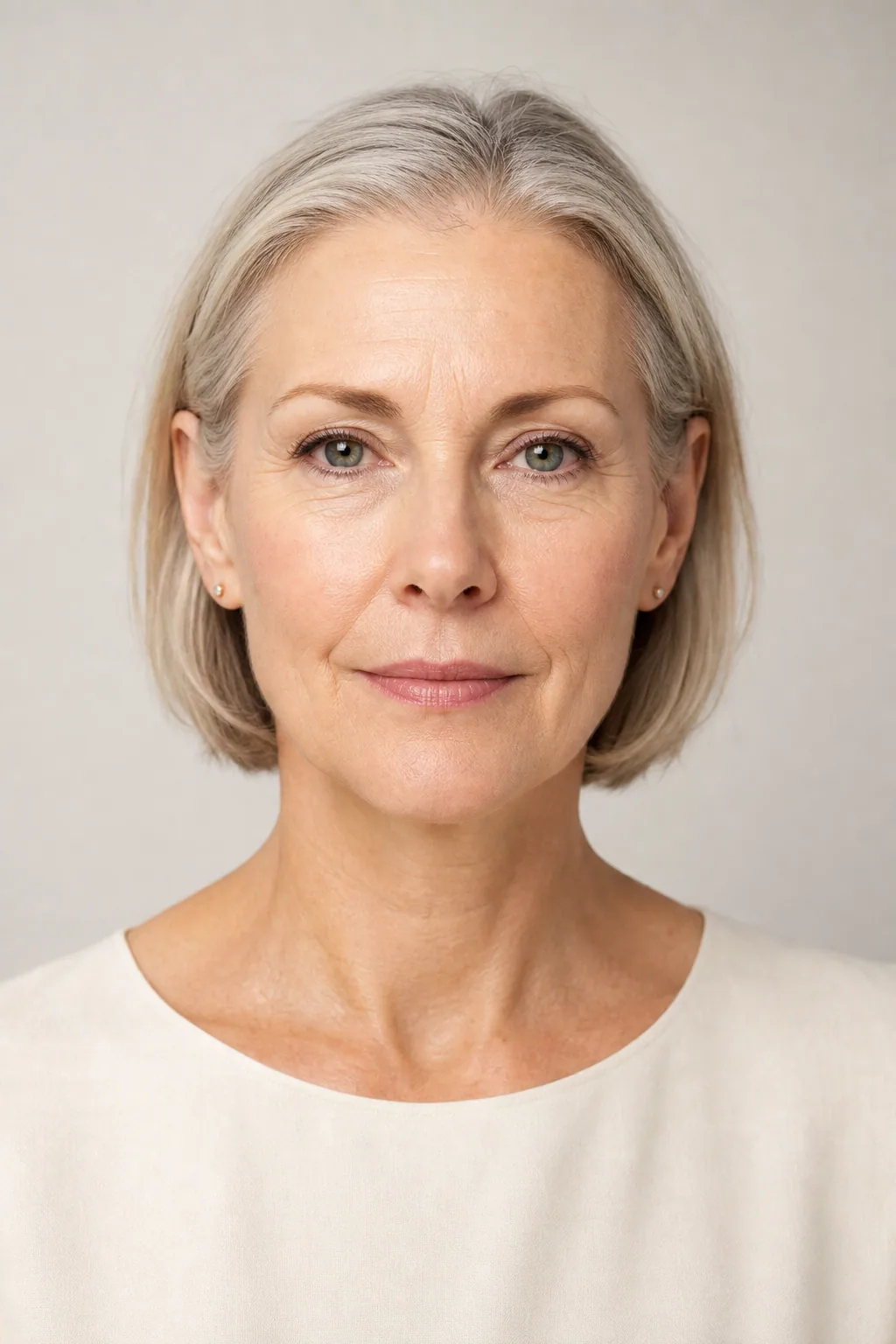Fine hair in a jaw-length bob tucked behind both ears, showing the full width of the forehead, front view