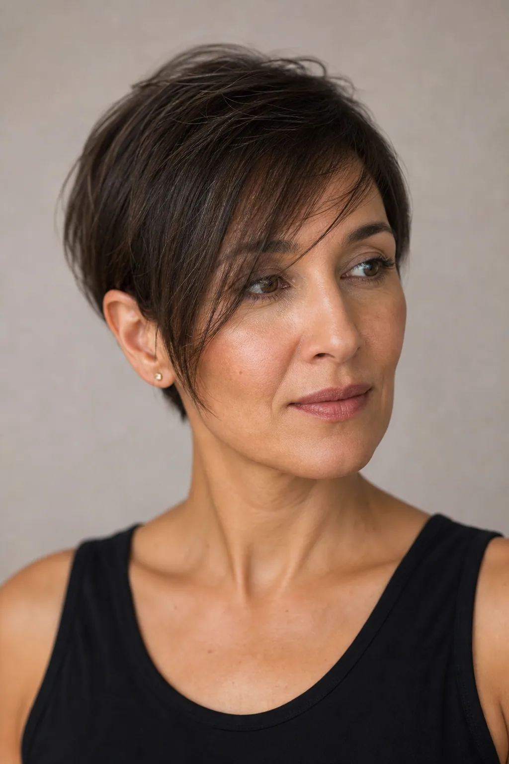 Longer side-swept fringe reaching the cheekbone, fine hair, three-quarter view with visible diagonal line