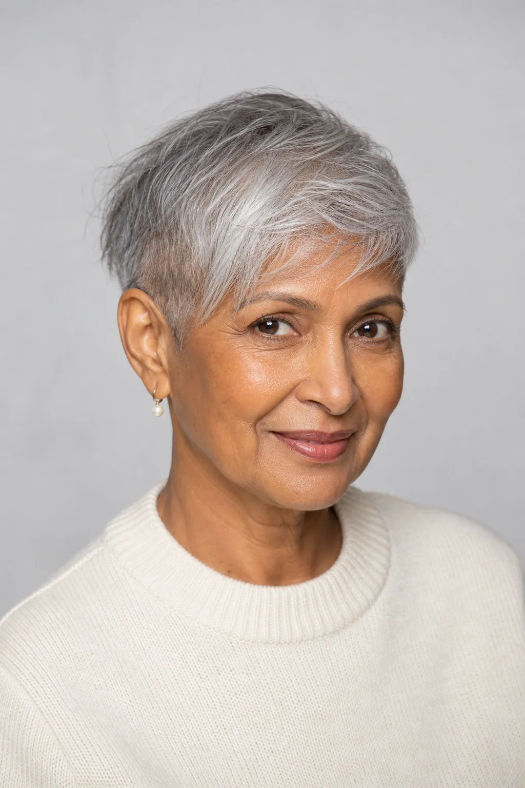 Salt-and-pepper pixie with a longer top and small side undercut on fine hair