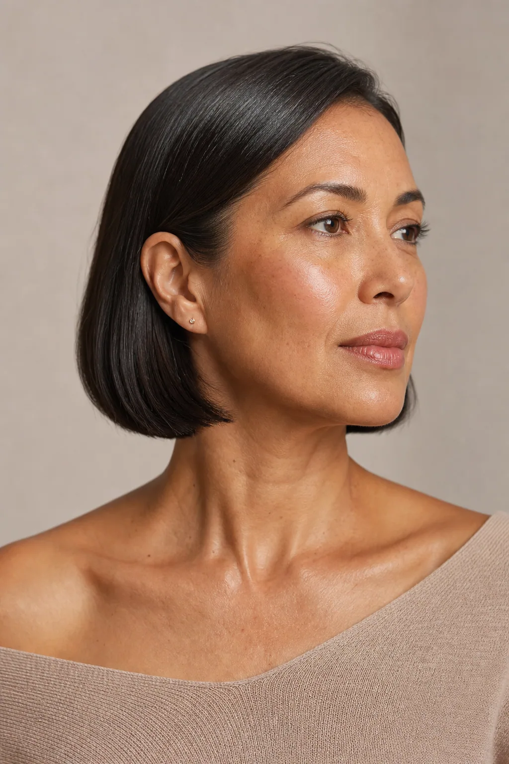 Sleek one-length bob tucked behind the ears with a glossy finish on fine straight hair