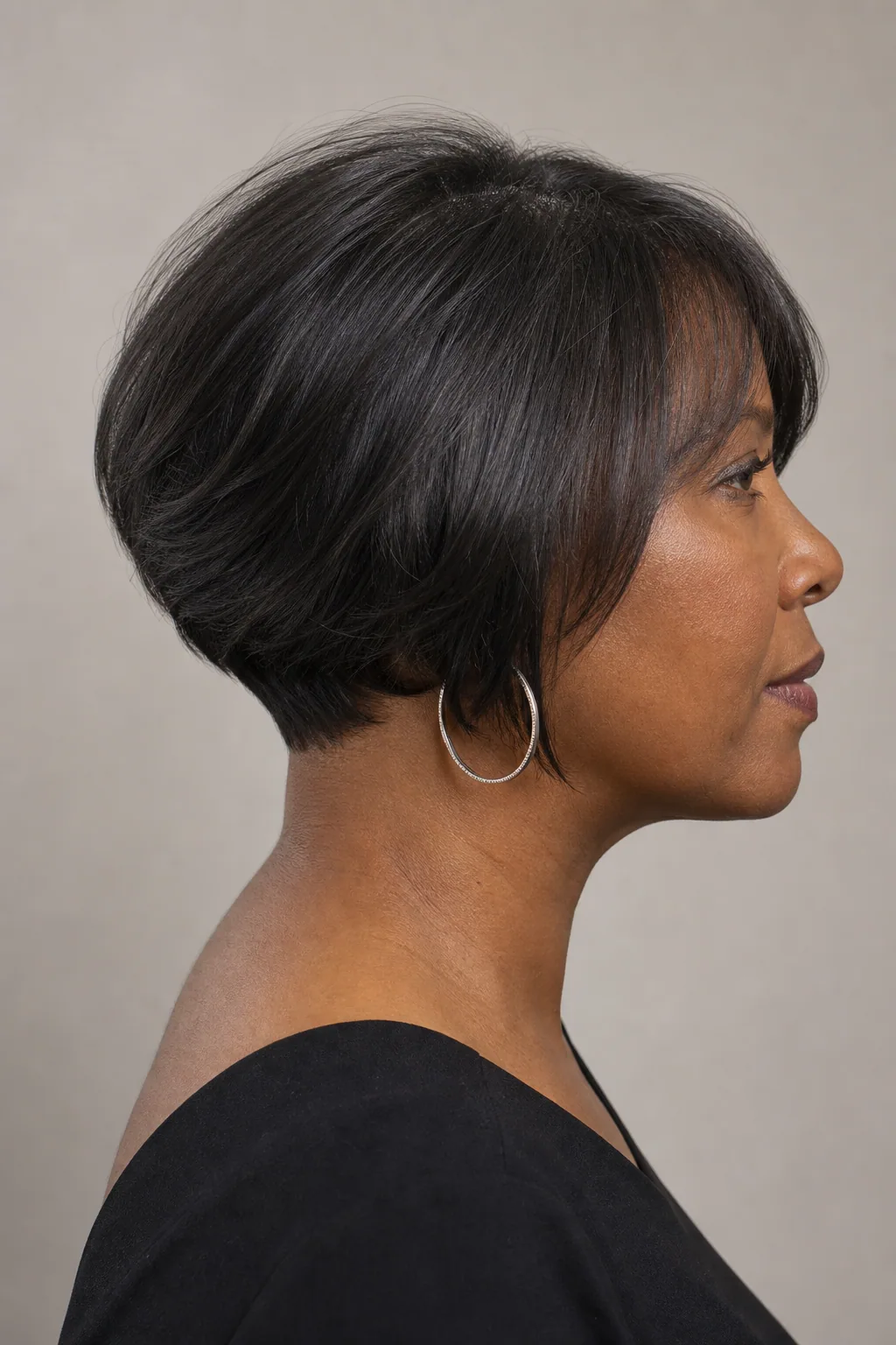 Fine hair in a stacked bob with graduation and volume at the back of the head, heart-shaped face, side profile