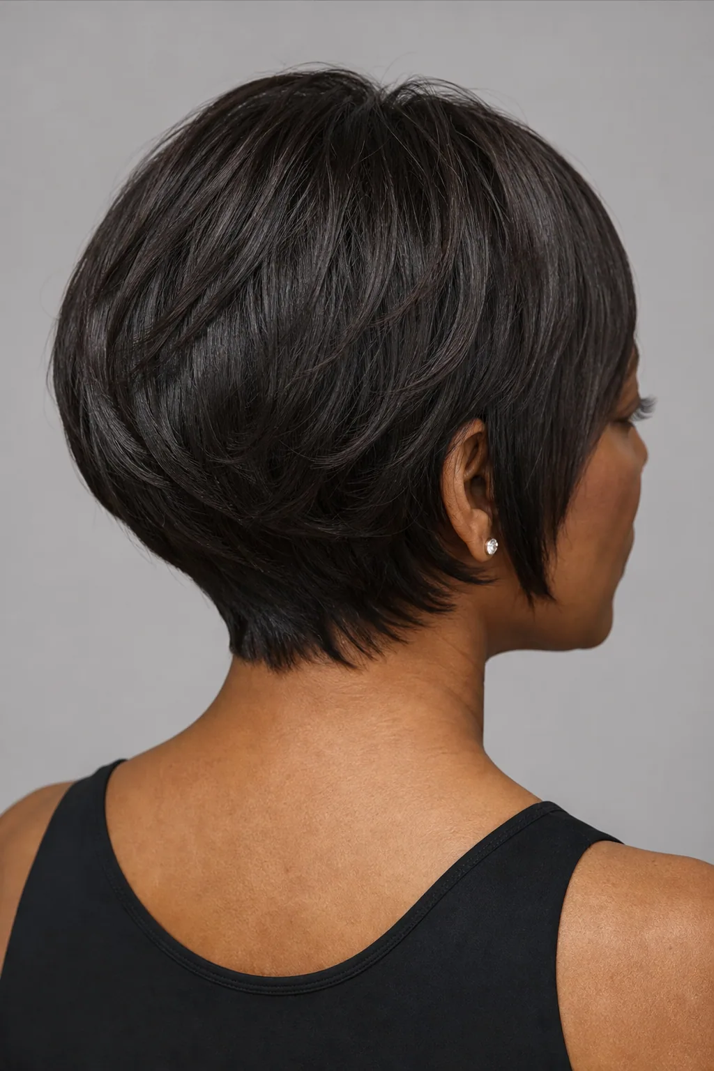 Back view of a stacked layered bob with graduated layers building a volume shelf on fine hair