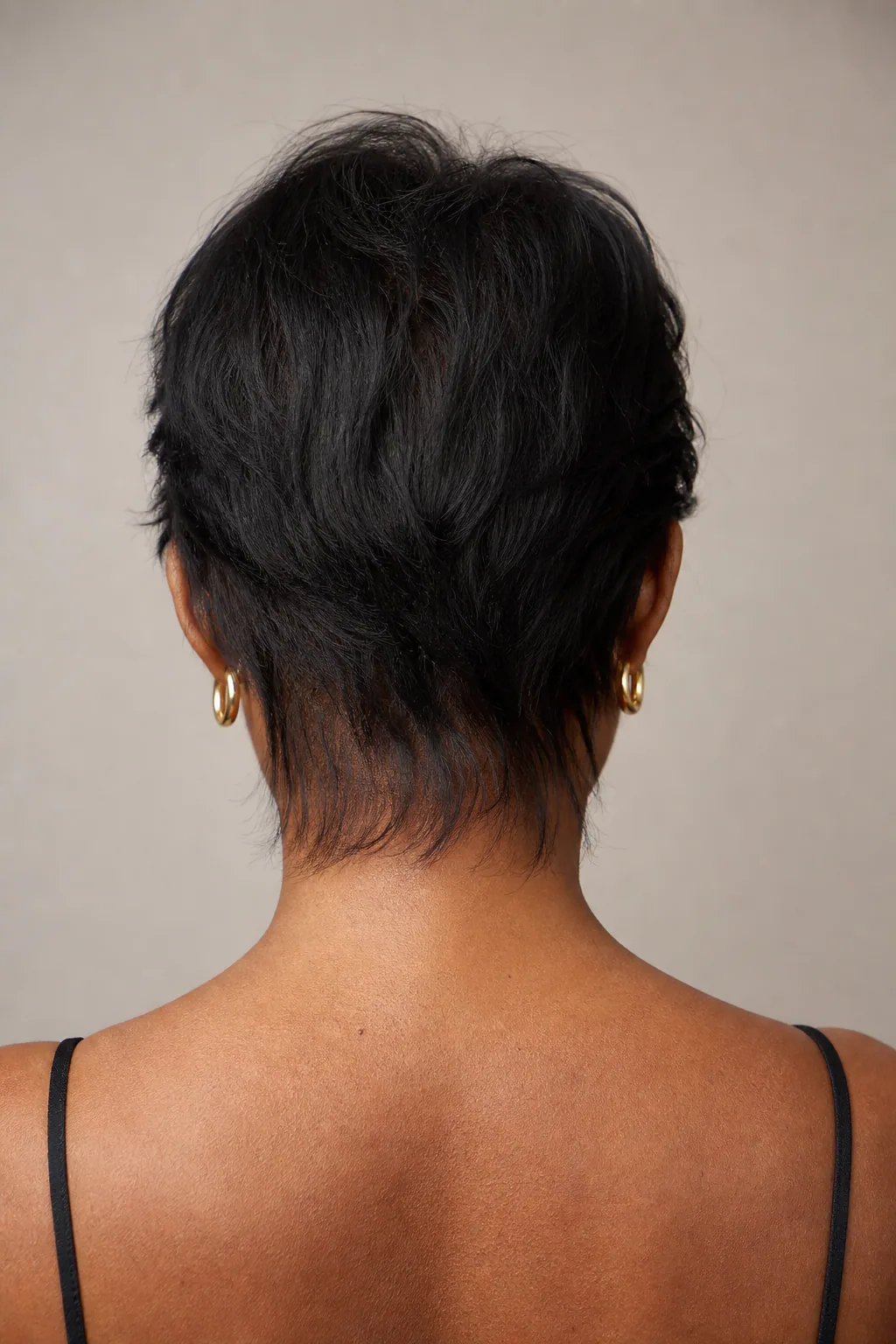 Mullet with softly tapered nape on fine hair, no hard line, close back view