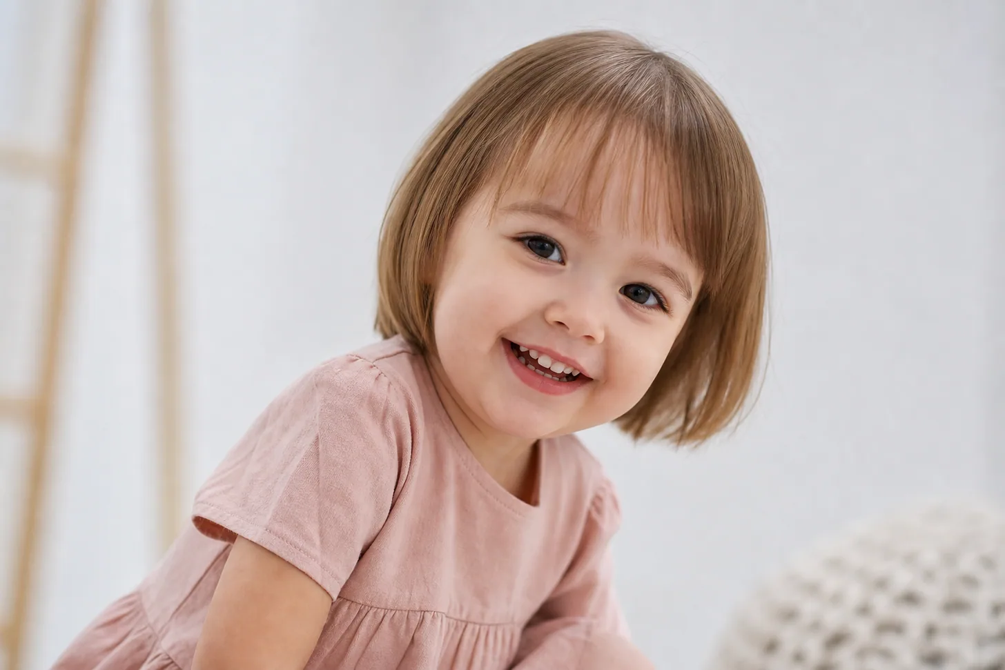 Toddler girl with a blunt chin-length bob and soft bangs on fine, thin hair