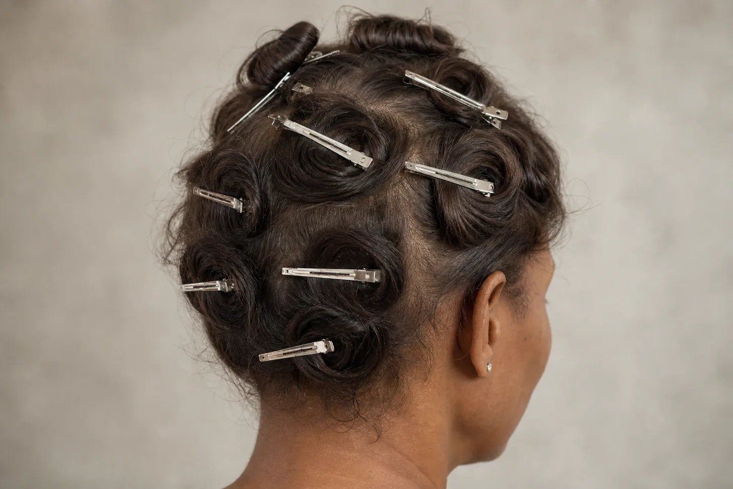 Cooled curls pinned to the head with flat clips before being released